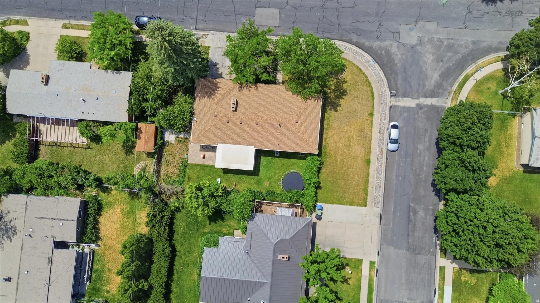 Property featuring a brown shingle roof, a rectangular footprint, and a front yard with a partial curb