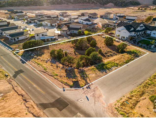 Corner lot offering a cleared building envelope, natural landscaping, and established roads