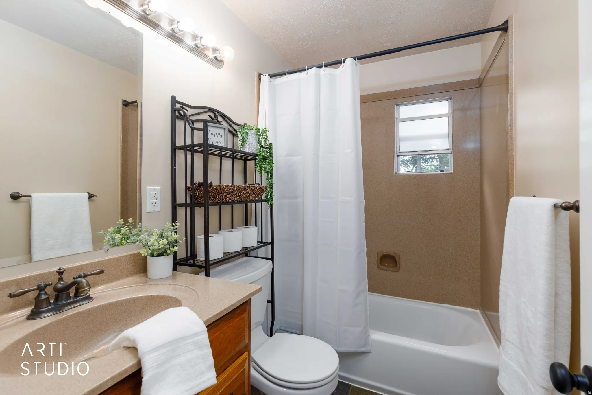 Bathroom vanity with an integrated sink, bronze-finish faucet, and wood-finish cabinetry