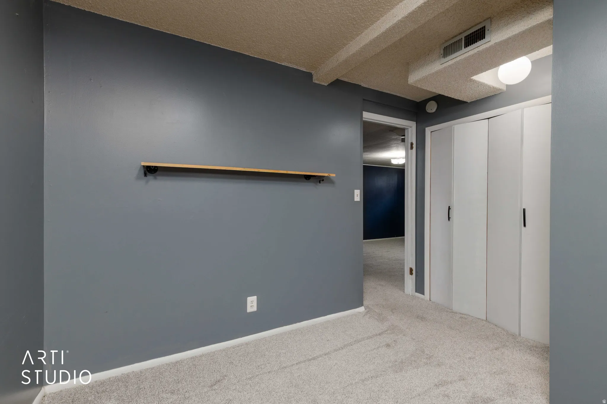 Wall-to-wall carpeting and a neutral color palette