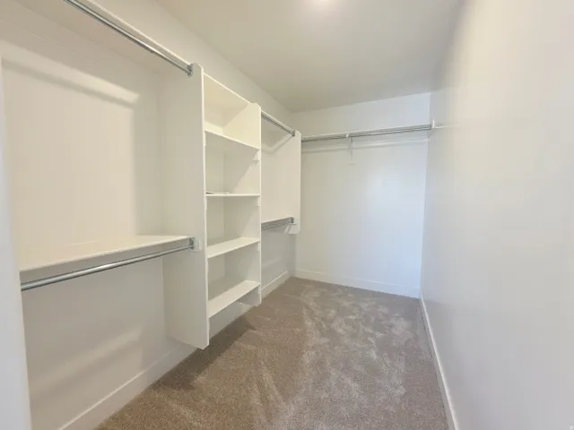 Custom closet system featuring shelving and hanging rods