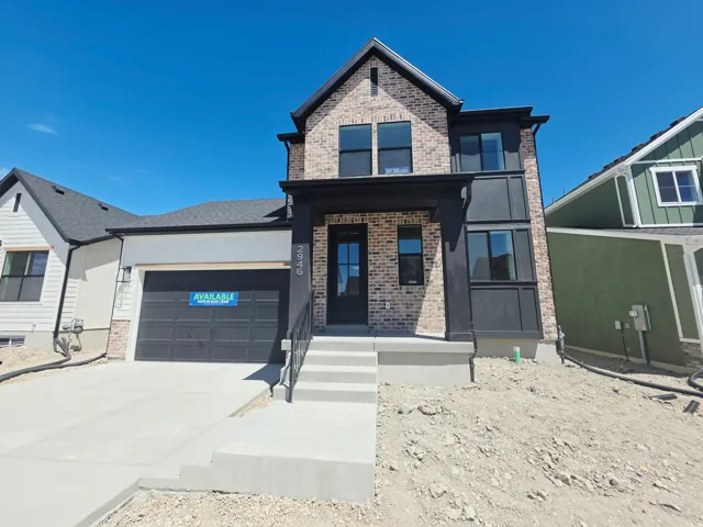 Modern two-story residence featuring a brick facade and dark trim accents
