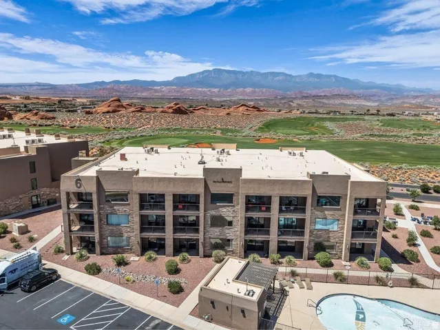 Multi-story building featuring stacked balconies and stone veneer accents