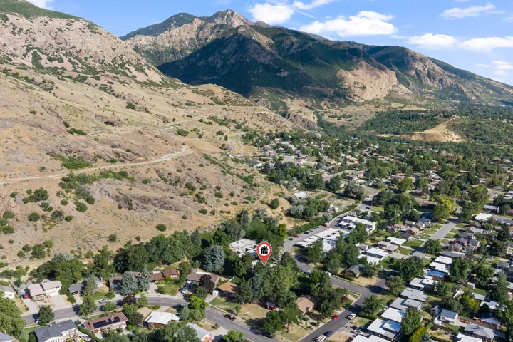 Aerial perspective showcasing a residential area set against a mountainous backdrop