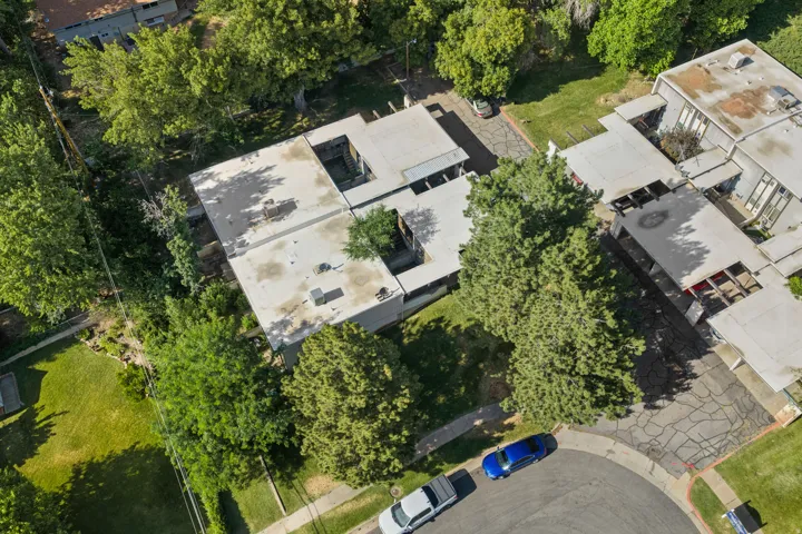 Aerial perspective showcasing a modern flat-roof structure with multiple courtyards
