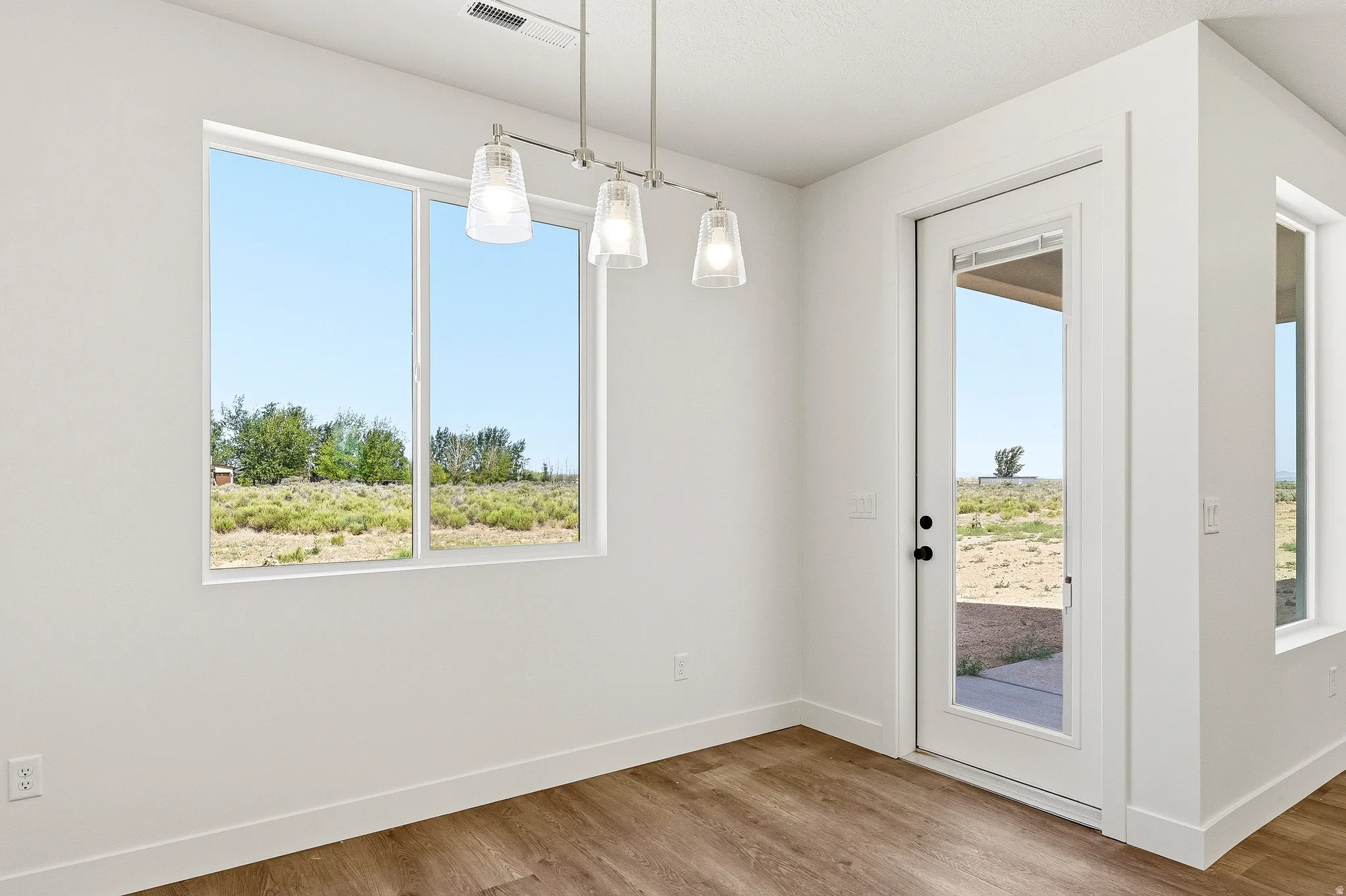 Interior space featuring wood-finish flooring and a white trim package