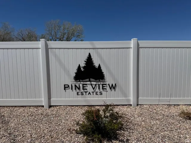 White panel fencing with decorative community signage