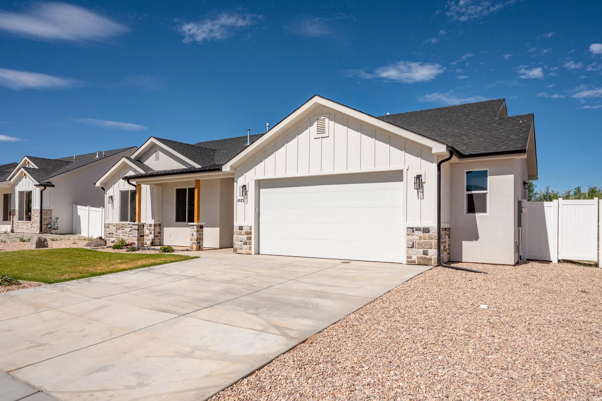 Modern facade with white board-and-batten siding and stucco finishes