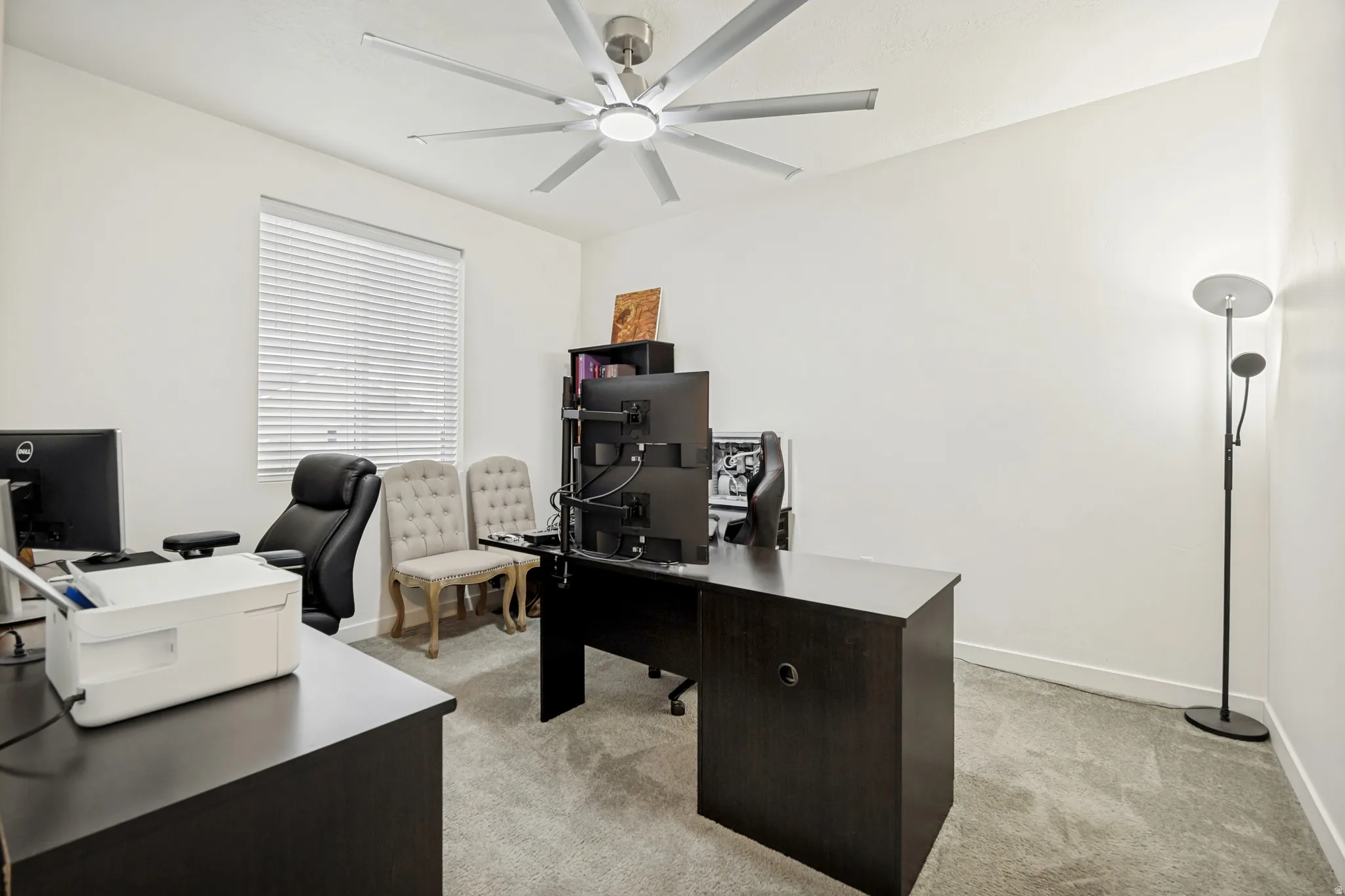 Light gray carpeting complements the bright white walls and ceiling