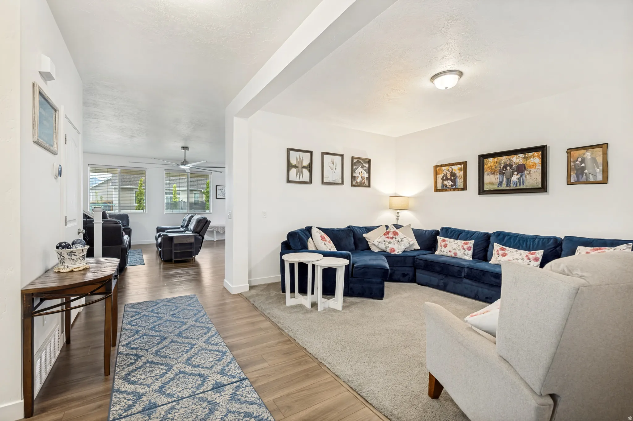 Bright interior featuring wood-finish flooring, white walls, and recessed lighting