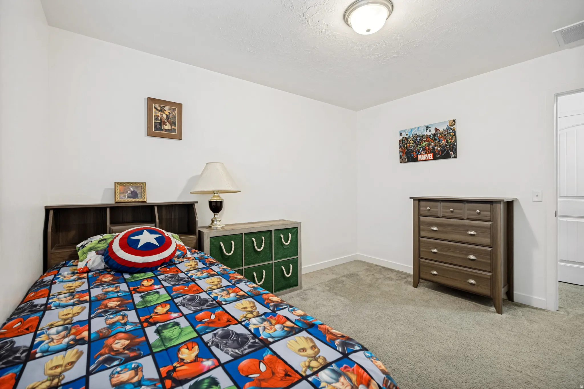 Carpeted interior room featuring bright white walls, white trim, and a white ceiling with a flush-mount light fixture