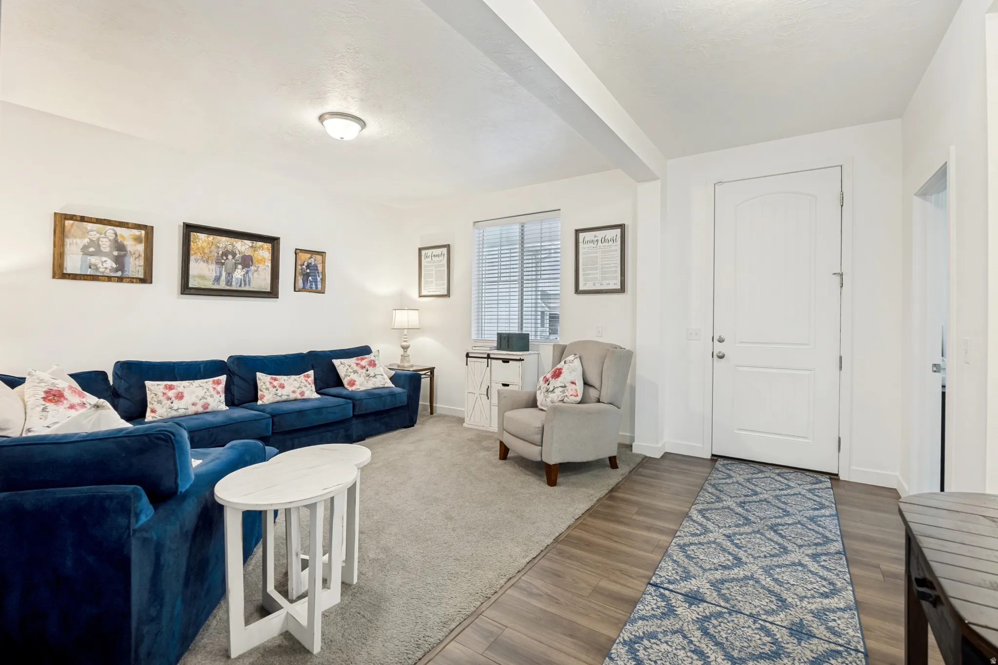 Welcoming entry space featuring wood-finish flooring, a white paneled door, and a recessed ceiling light