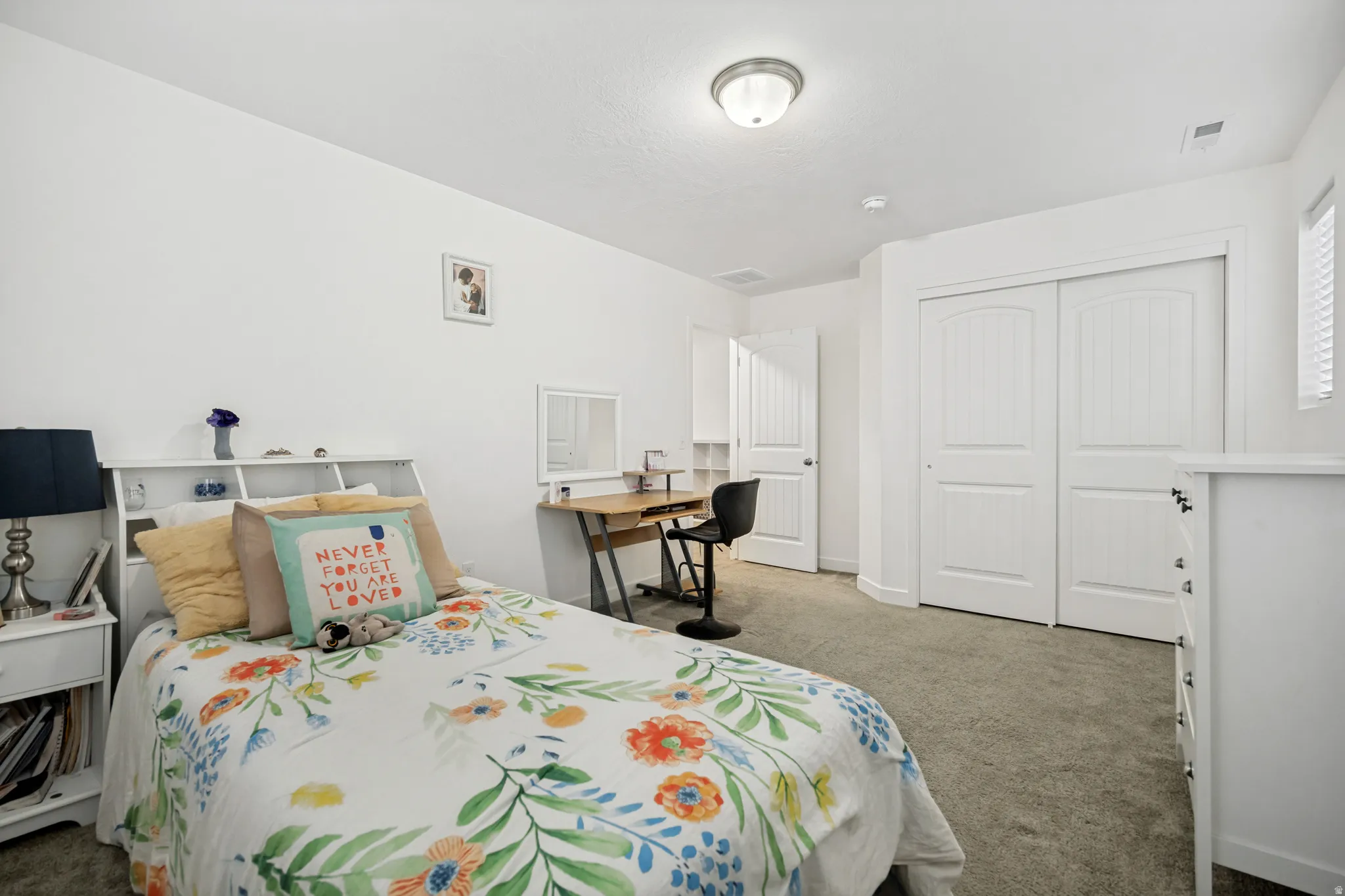 Carpeted room with a ceiling-mounted light fixture