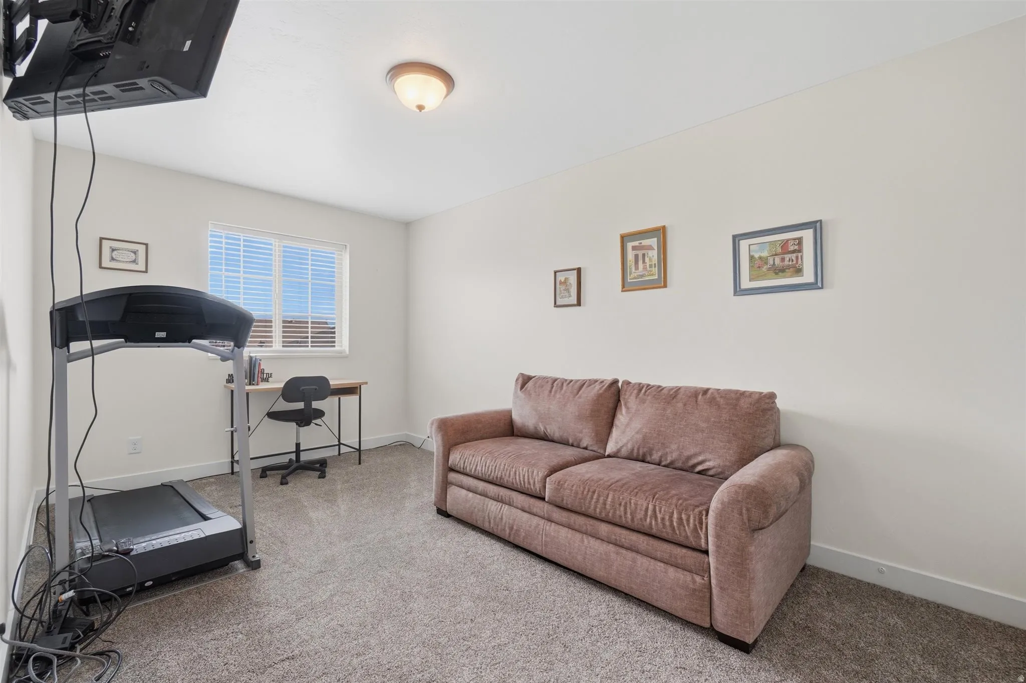 Bright room with light-toned walls and neutral carpet flooring