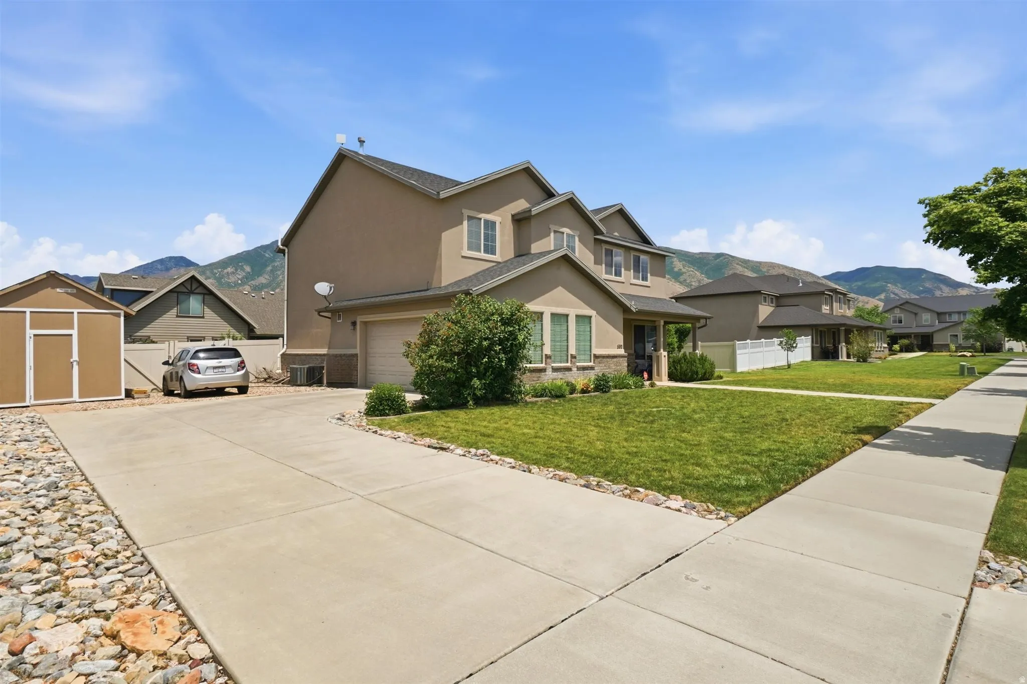 Contemporary two-story residence with stucco exterior and a side-facing garage