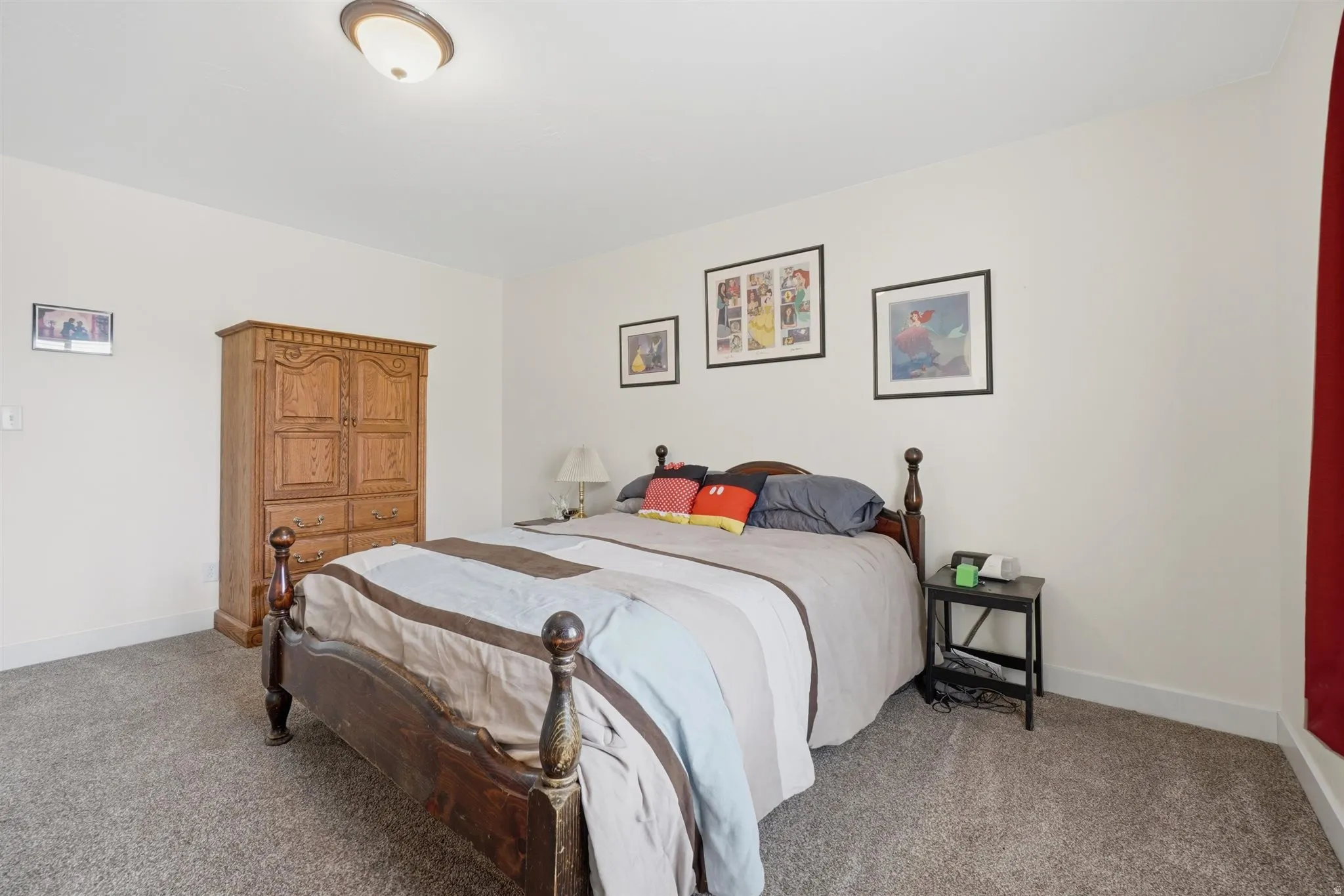Spacious room featuring neutral carpeting and white walls
