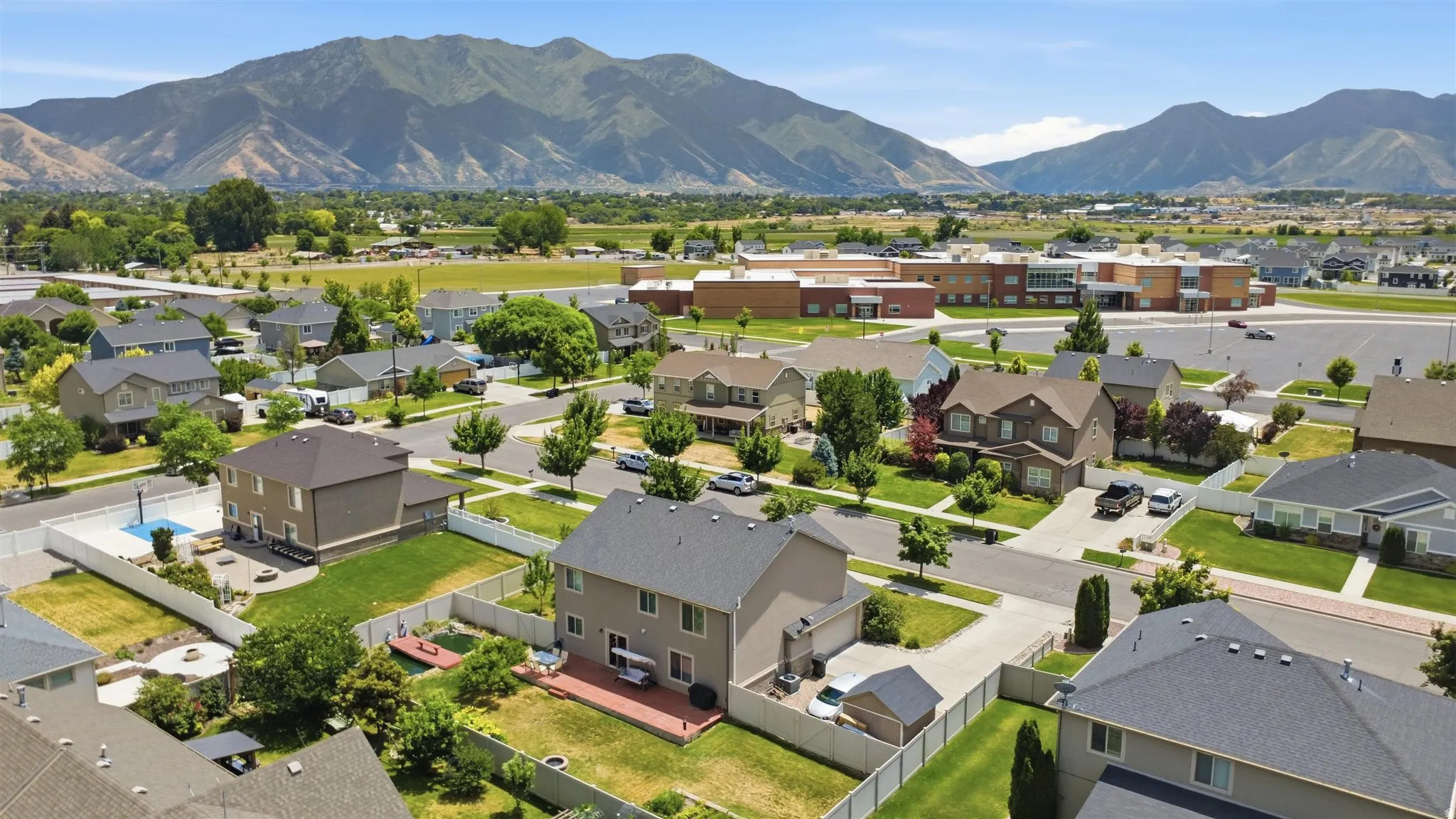Residential neighborhood featuring multiple two-story homes with pitched roofs and manicured lawns