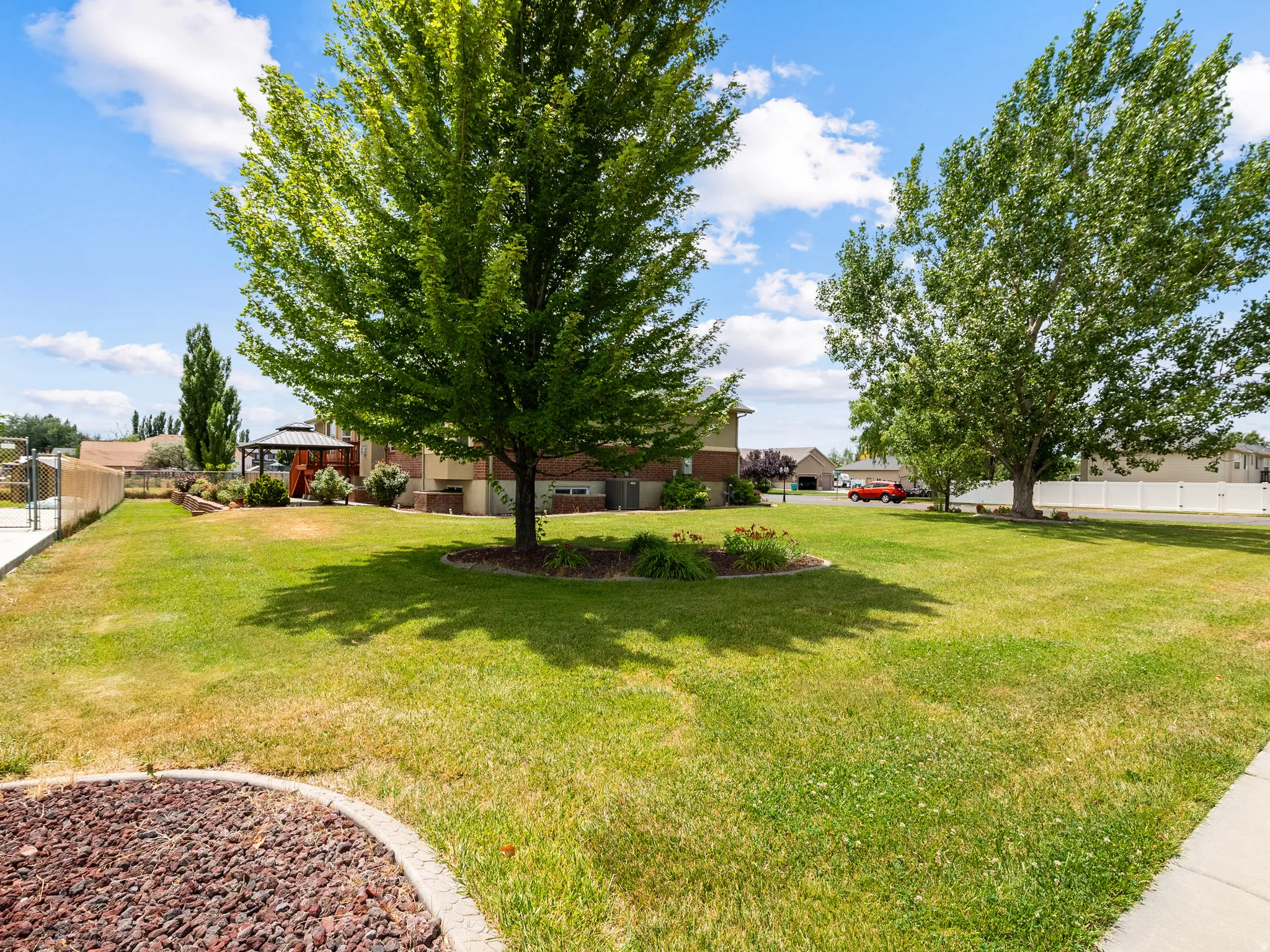 Expansive green lawn with mature shade trees