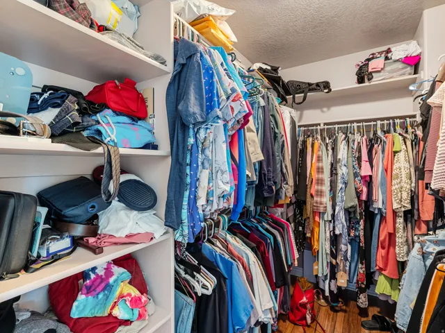 Custom closet system featuring built-in shelving and multiple clothing rods