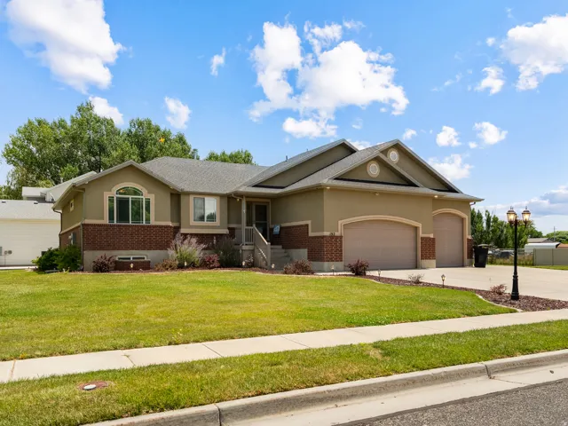 Stucco and brick exterior with a large arched window and a covered entry porch