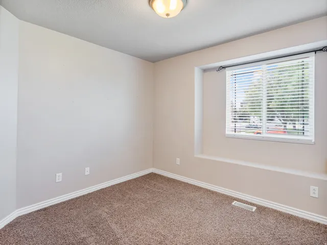 Recessed window with white blinds and decorative rod
