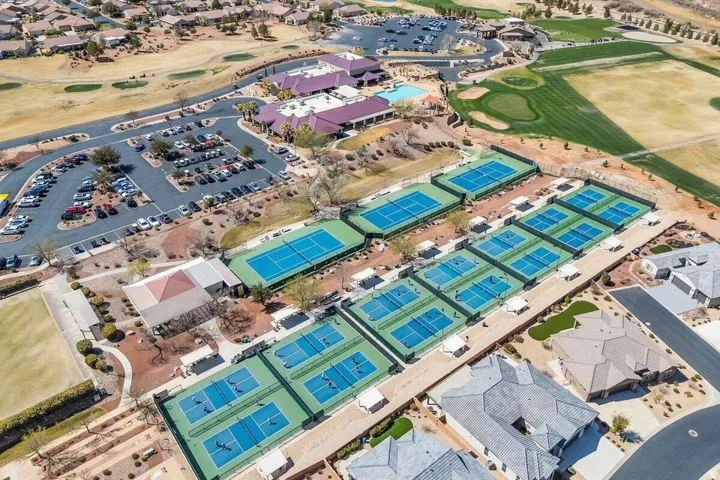 Extensive recreational complex featuring multiple tennis courts, pickleball courts, and a manicured golf course
