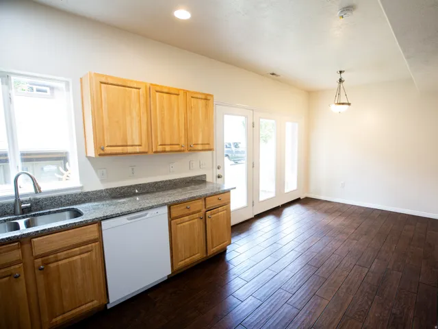 Kitchen and dining area featuring wood-finish flooring