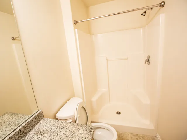 Full stand-up shower with a chrome shower head and fixtures
