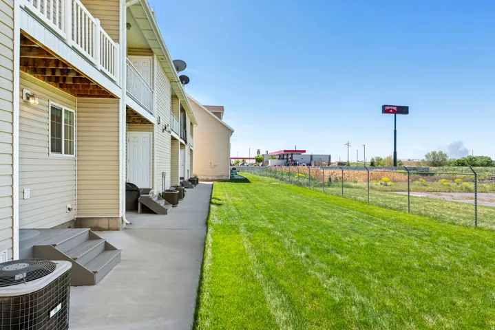Exterior siding with multiple balconies and ground-level patios
