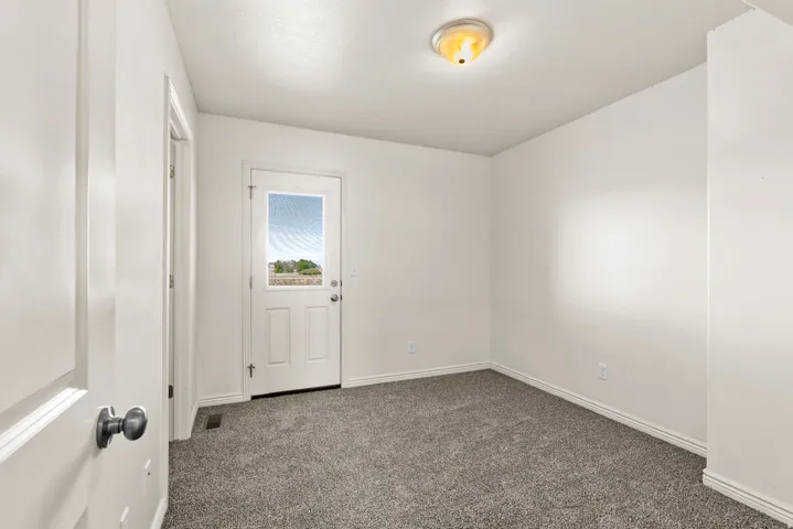 Neutral tone wall finish with a white trim, complemented by a semi-flush mount ceiling light fixture