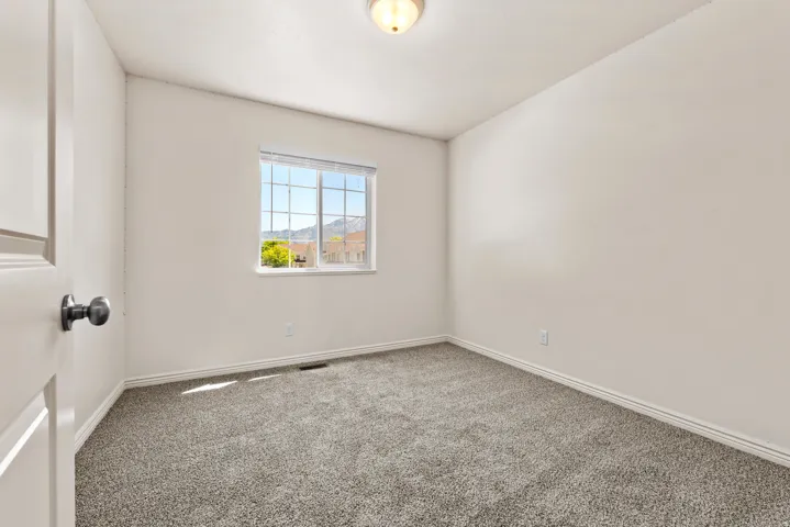 Neutral wall tones and plush gray carpeting create a versatile interior