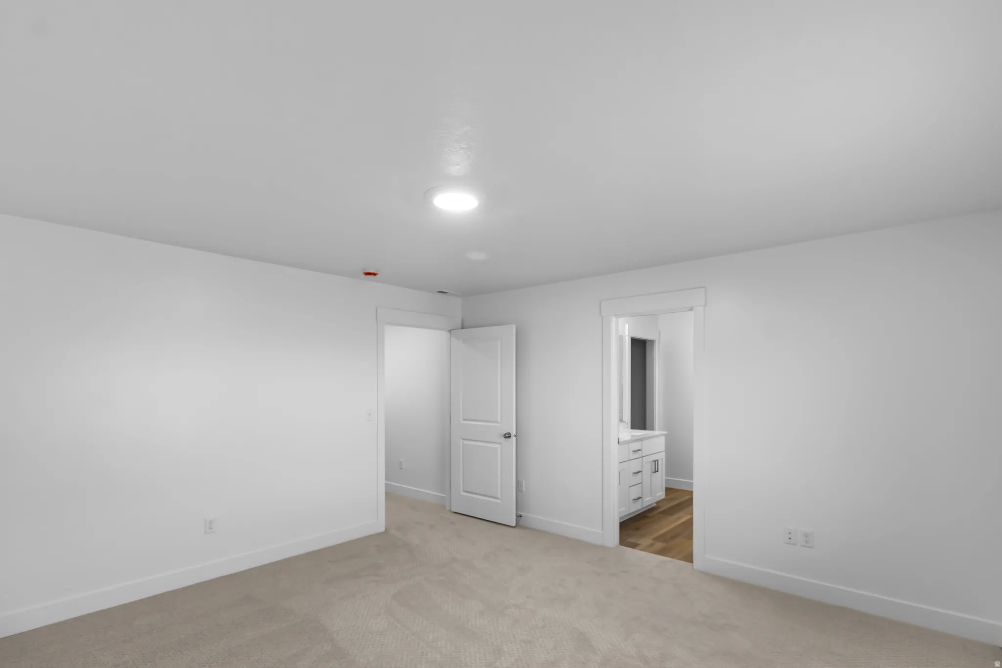 Neutral color palette featuring carpeted flooring and recessed lighting