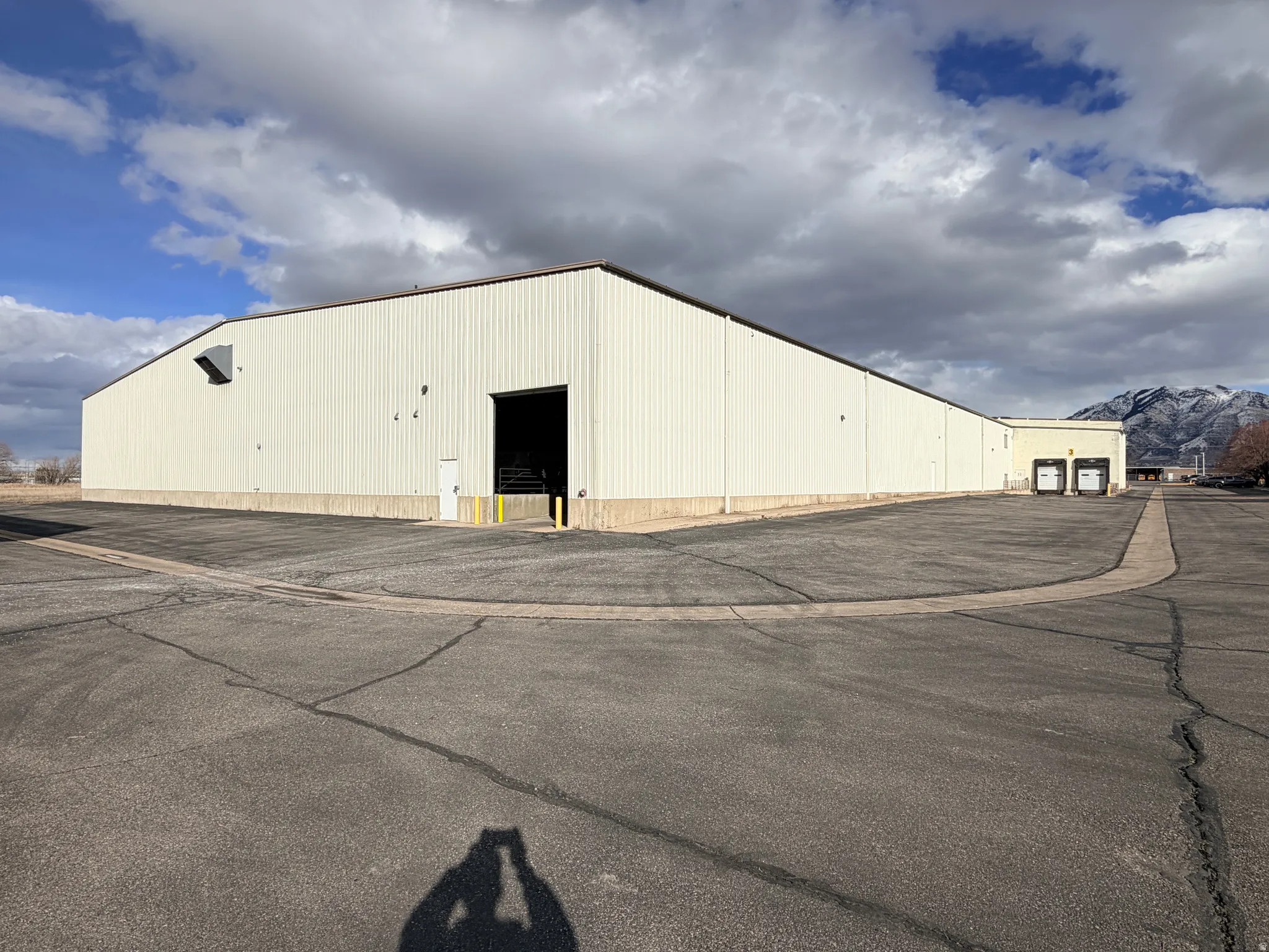 Industrial manufacturing building featuring a corrugated metal exterior and a flat roofline