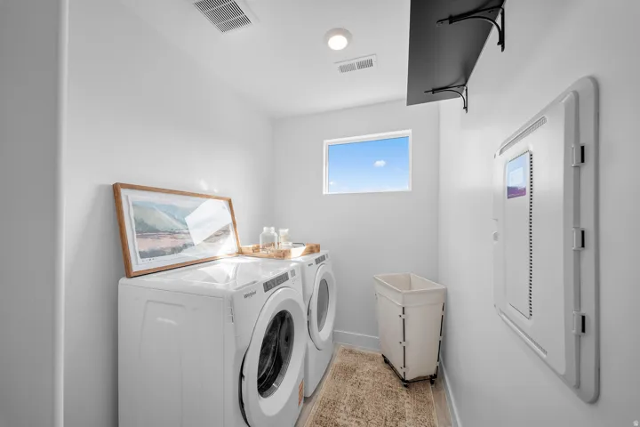 Dedicated laundry room featuring white walls, a recessed ceiling light, and a small horizontal window