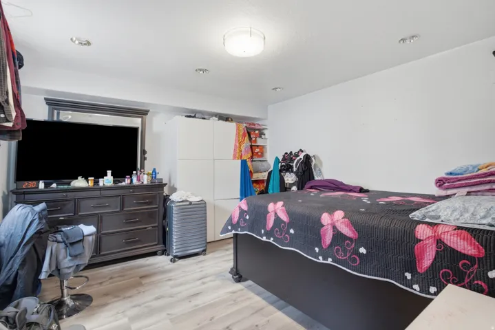 Bedroom featuring light wood-finish flooring, recessed lighting, and a flush-mount ceiling light fixture