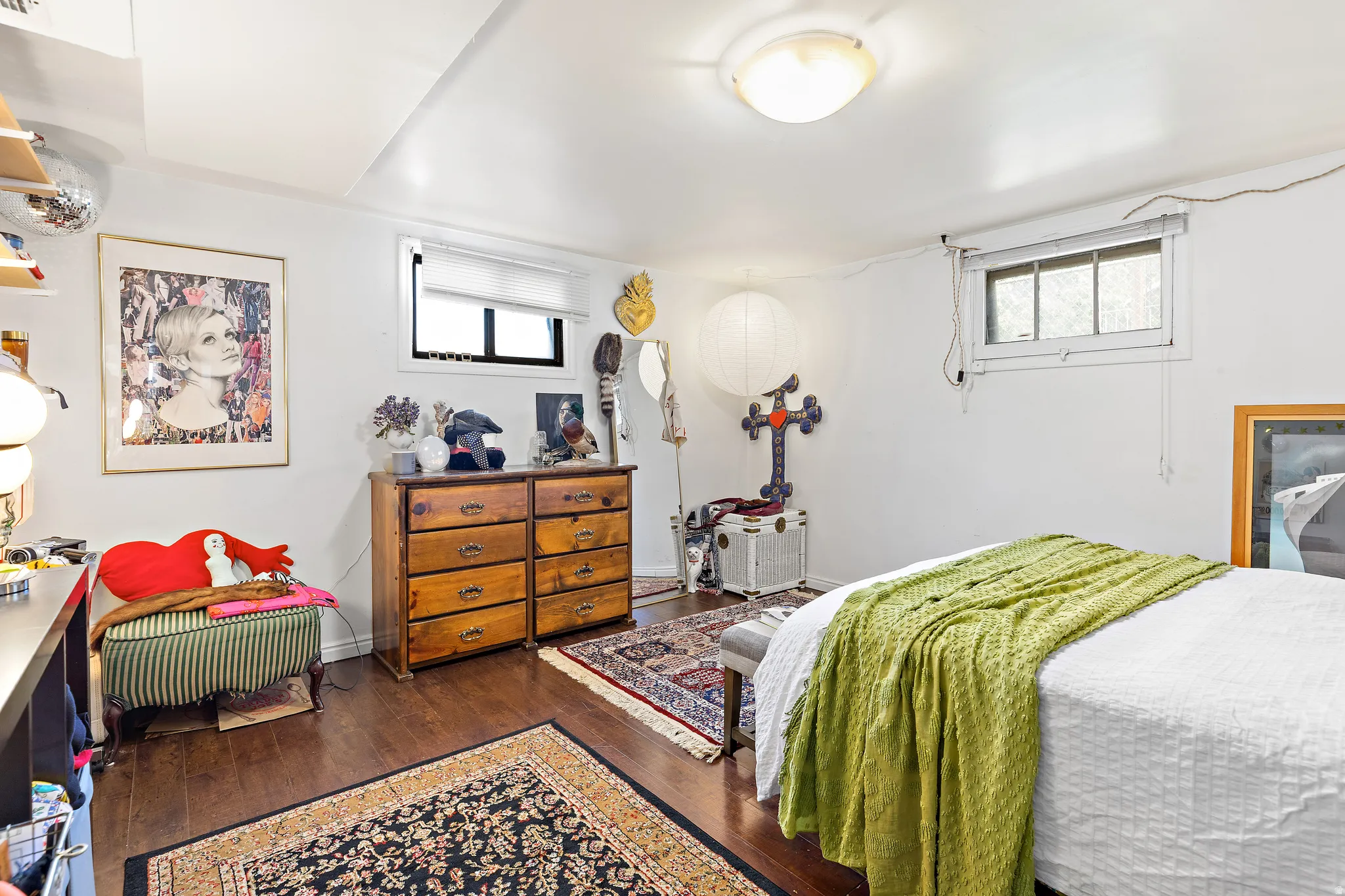 Spacious room featuring wood-finish flooring, white walls, and a recessed window