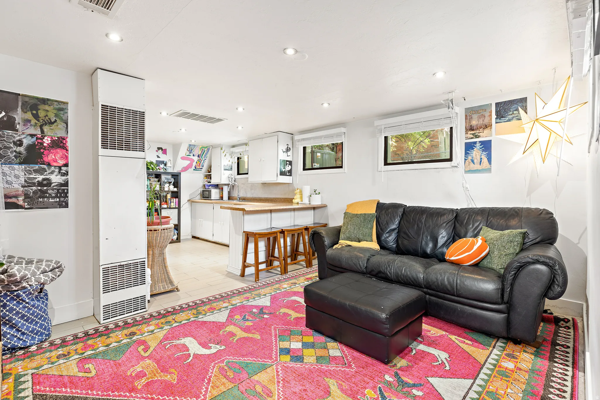 Open-concept living area with tile flooring and recessed lighting