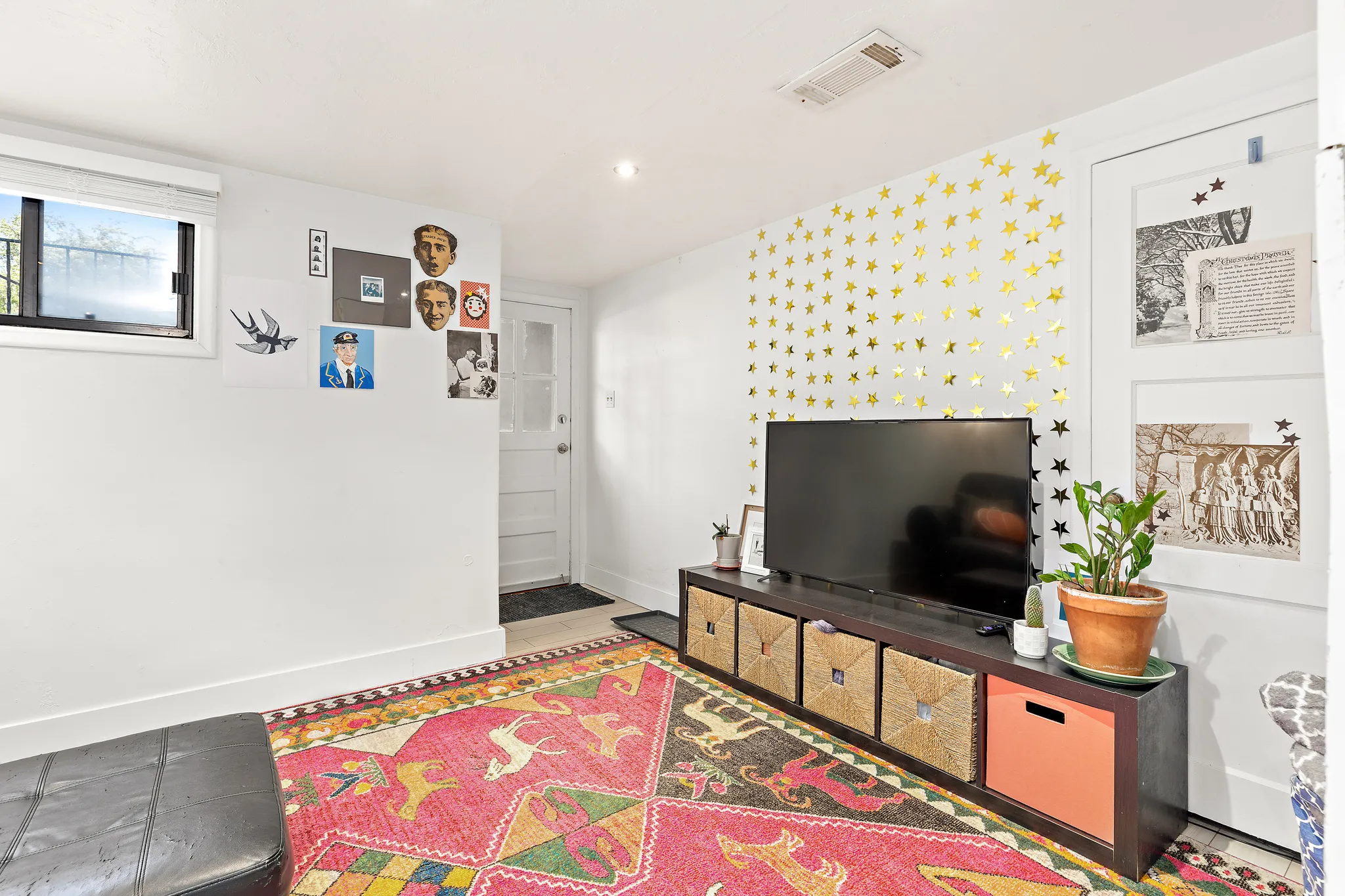 White walls with a single horizontal window featuring a dark frame