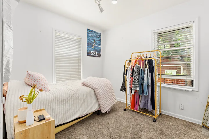 Bright room with light-colored walls and soft carpet flooring