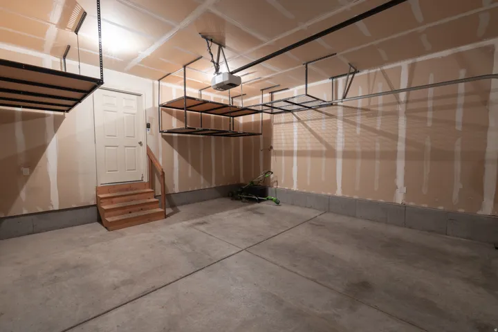 Concrete flooring with elevated storage racks and a panel door
