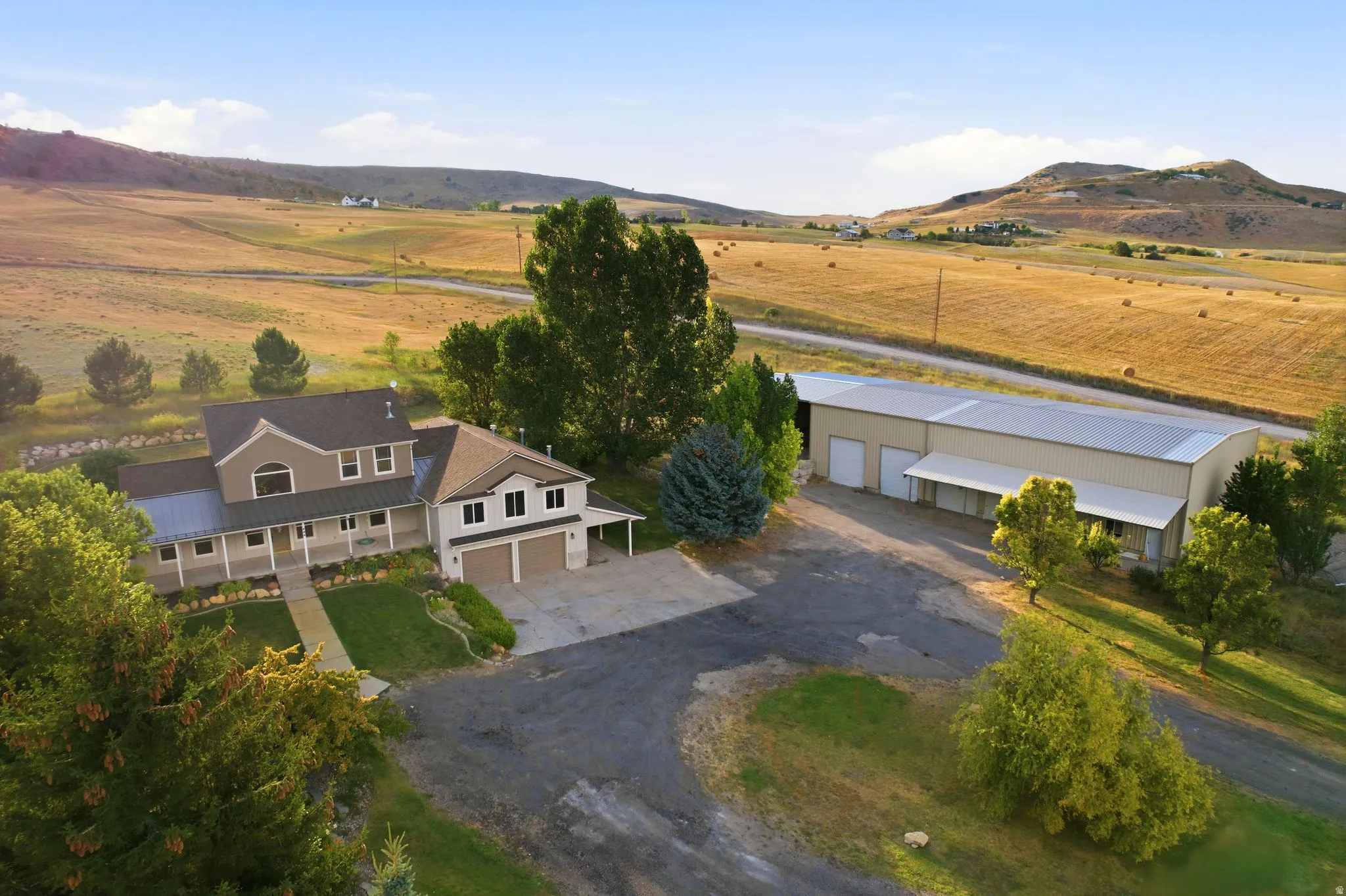 Expansive property featuring a two-story residence with a covered porch and an attached two-car garage