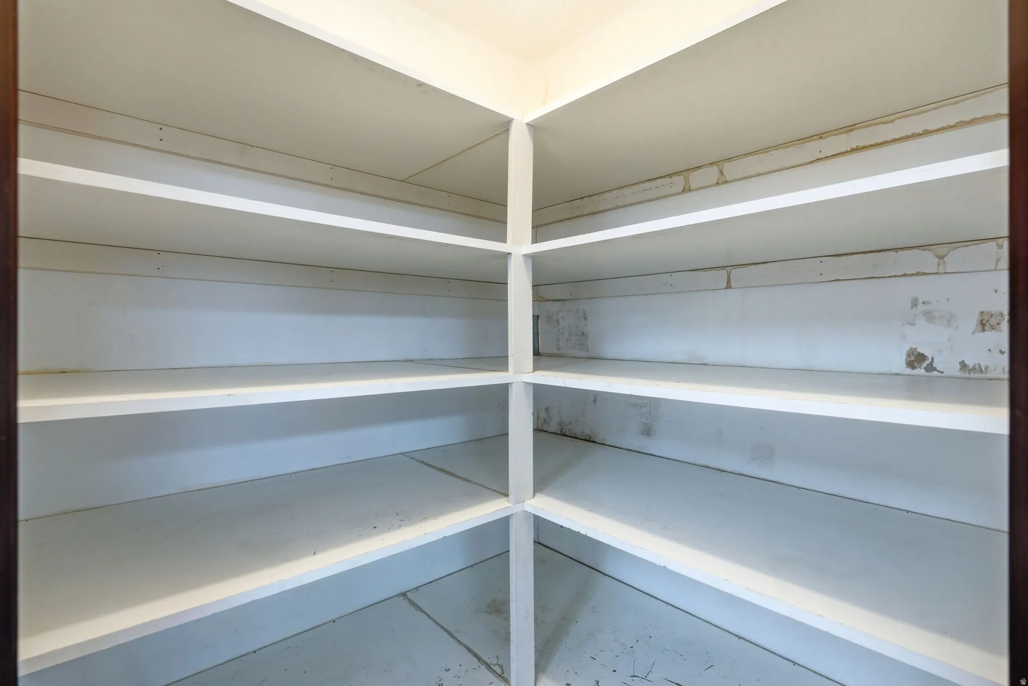 1st kitchen pantry with corner shelving unit with multiple white storage shelves