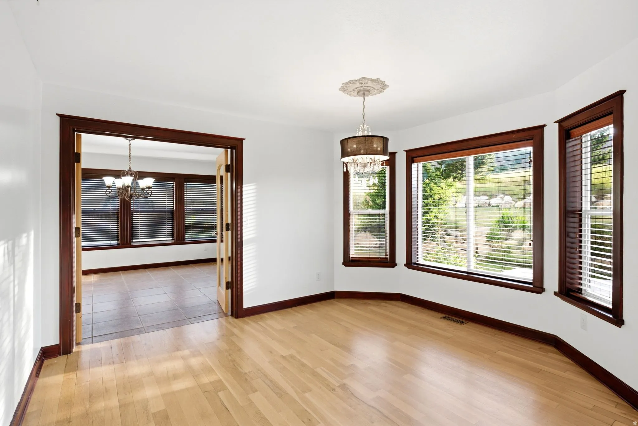Light wood-finish flooring with white walls and dark wood trim