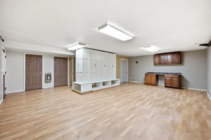 Main home basement. Spacious room featuring light wood-finish flooring