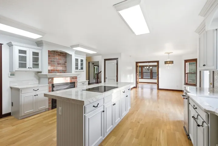 Open-concept kitchen and living area featuring light wood-finish flooring