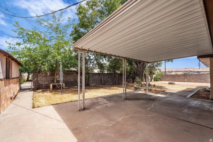 Expansive concrete patio area featuring a covered awning