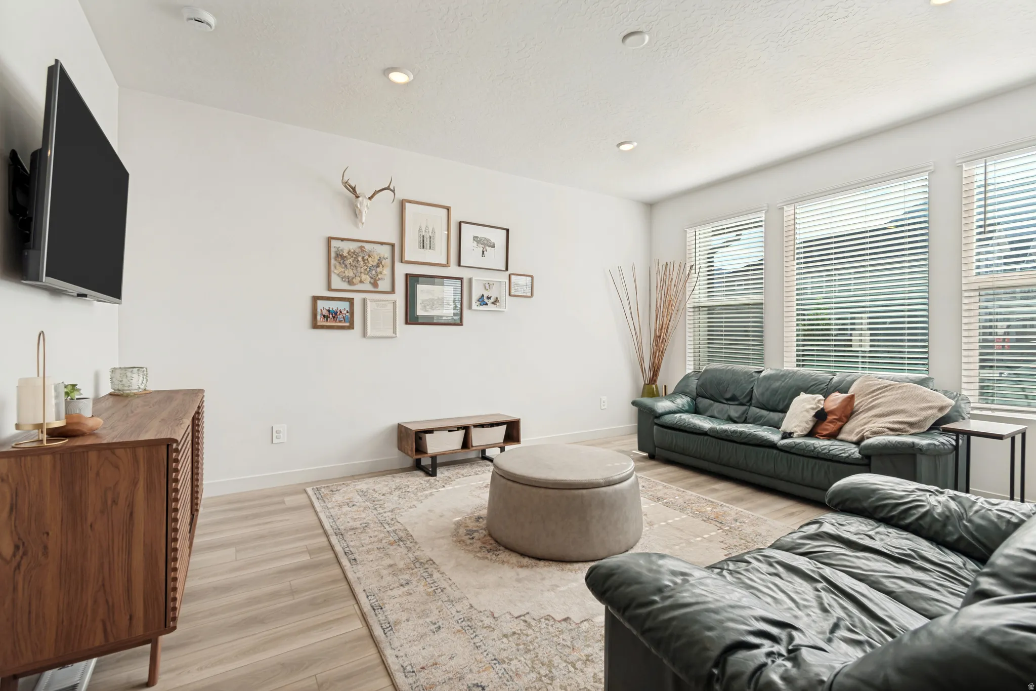 Bright living area featuring light wood-finish flooring