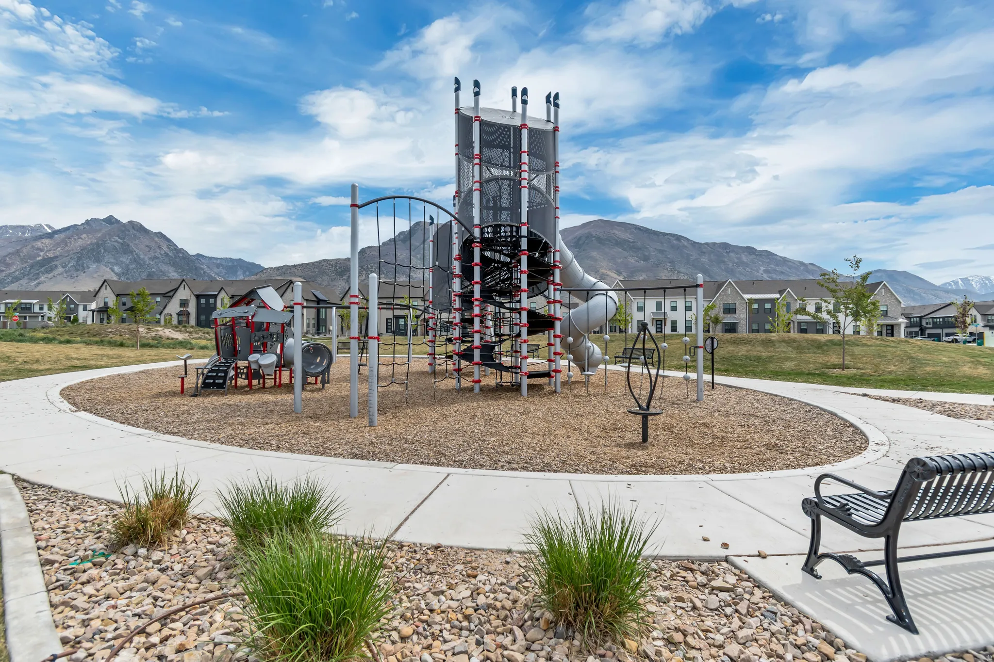 Community playground featuring a multi-level play structure with slides and climbing elements