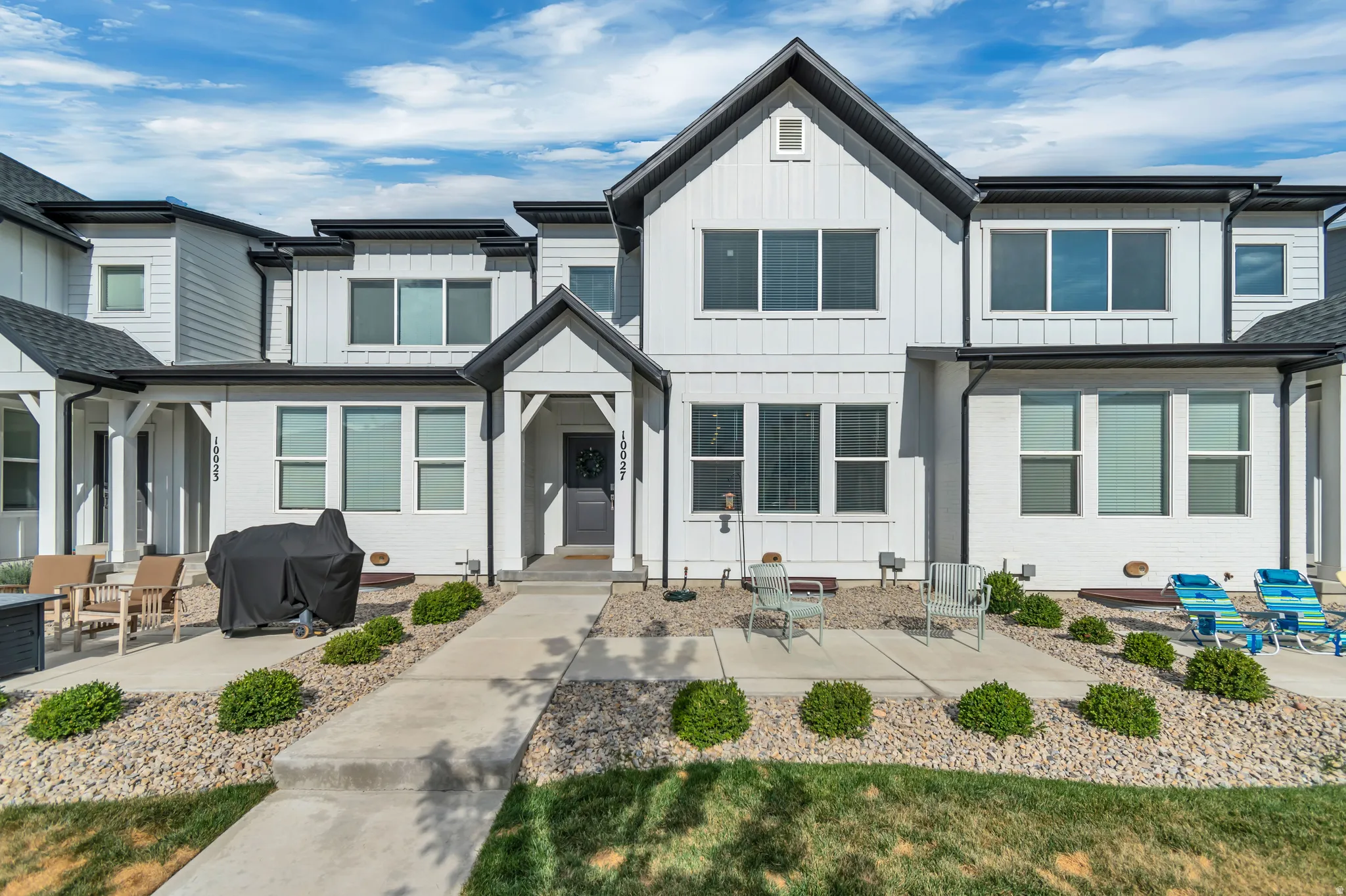 Modern townhome exterior with crisp white vertical and horizontal siding