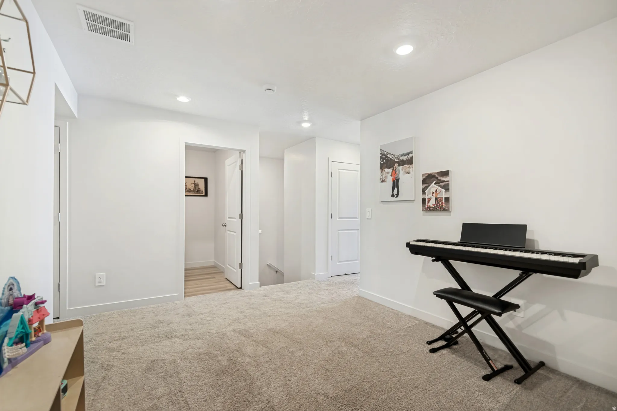 Carpeted area featuring recessed lighting, white walls, and white trim